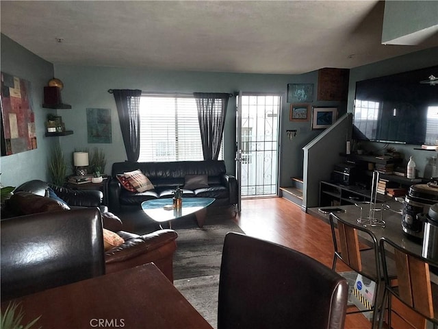 living room featuring stairway and wood finished floors