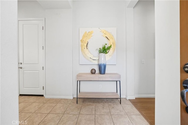 interior space featuring light tile patterned floors and baseboards