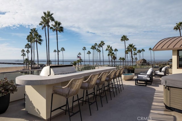 view of patio / terrace featuring outdoor wet bar and a water view