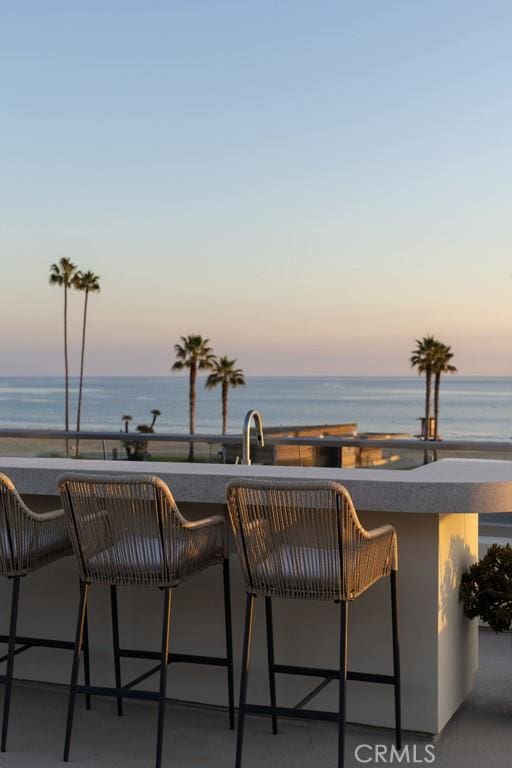 view of patio featuring a water view and a sink