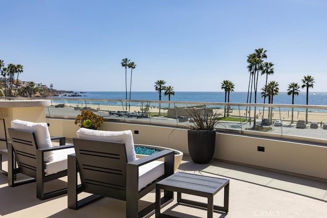 view of patio / terrace featuring a water view and a balcony