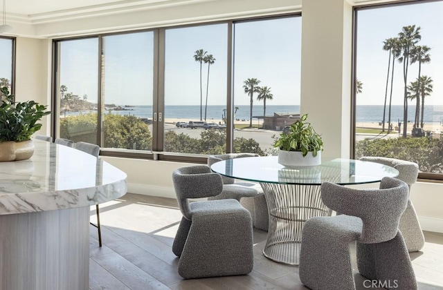 sunroom / solarium featuring a water view