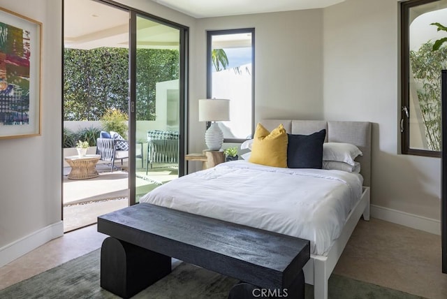 bedroom featuring baseboards and access to exterior