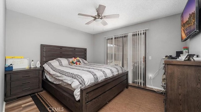 bedroom featuring a textured ceiling, access to outside, ceiling fan, and wood finished floors