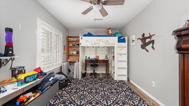 bedroom featuring a ceiling fan, visible vents, baseboards, and wood finished floors