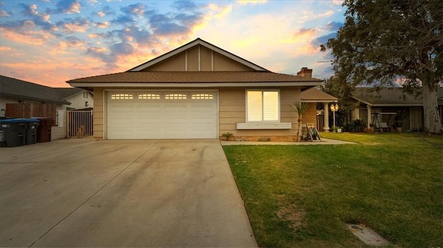 single story home featuring a front yard, driveway, a chimney, and an attached garage