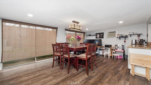 dining area with a wall unit AC, dark wood finished floors, and recessed lighting