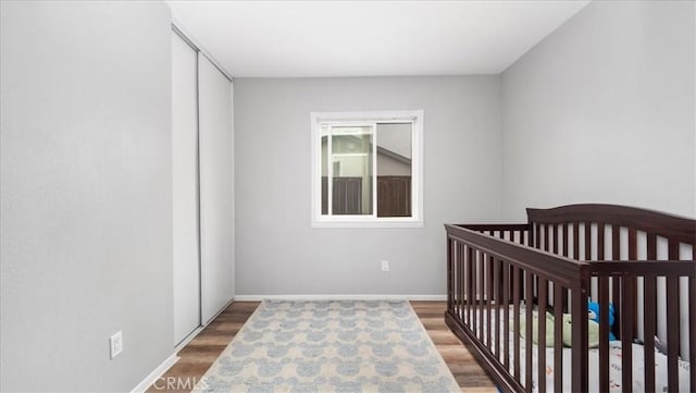 bedroom featuring baseboards and wood finished floors