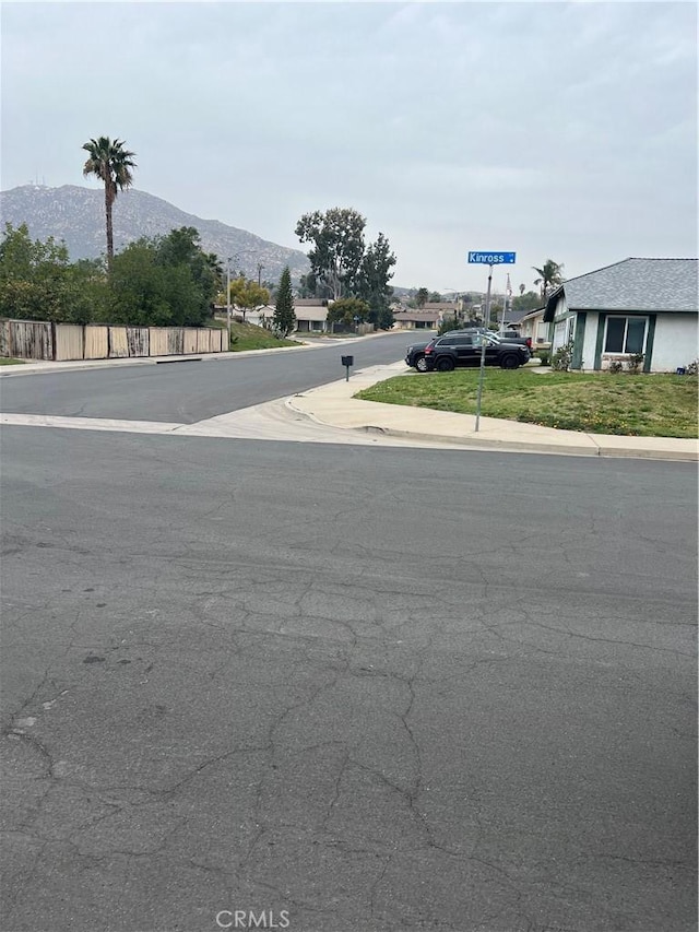 view of street with sidewalks and a mountain view