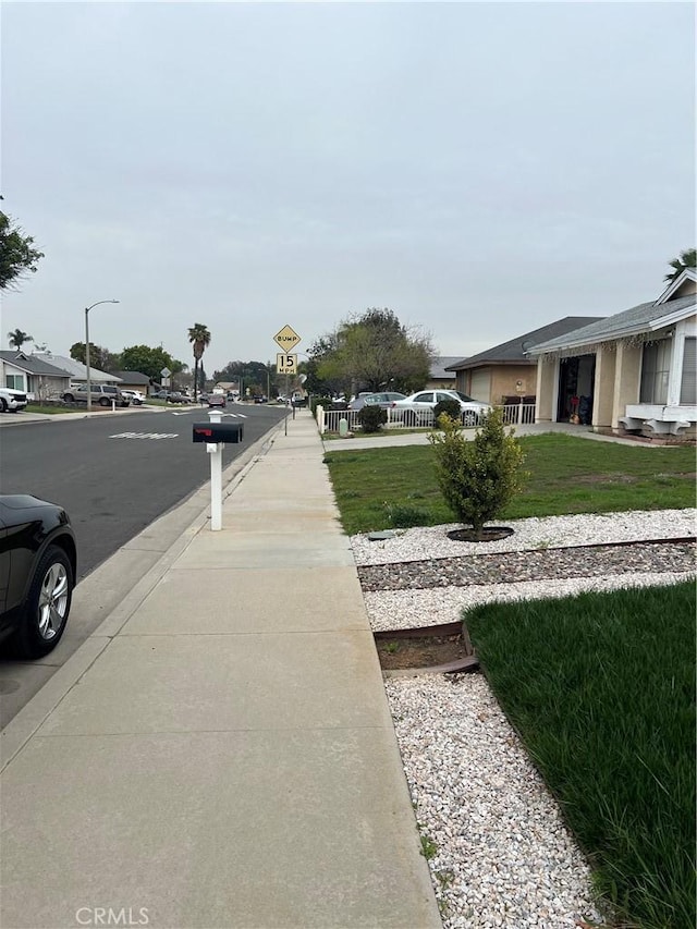 view of road featuring street lighting and sidewalks