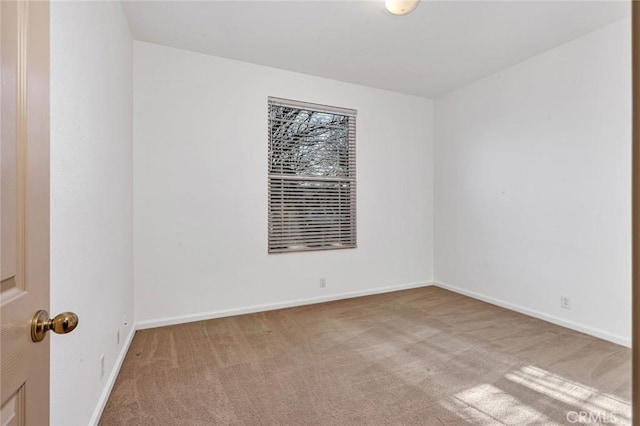 unfurnished room featuring baseboards and carpet flooring