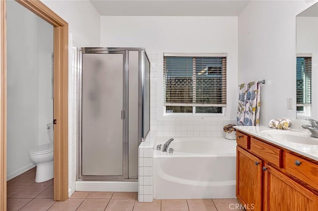 full bath with a stall shower, vanity, a bath, and tile patterned floors