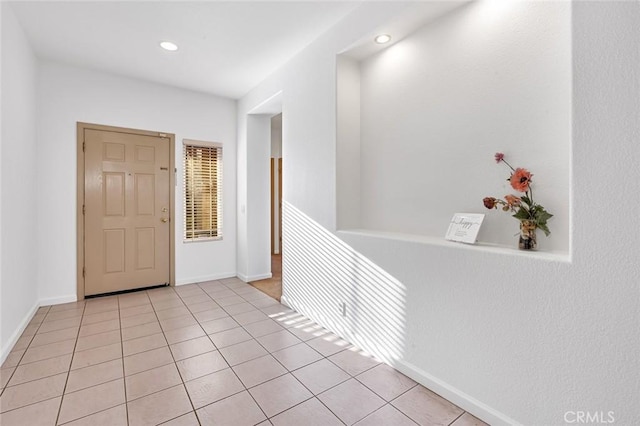 foyer with light tile patterned floors, recessed lighting, and baseboards