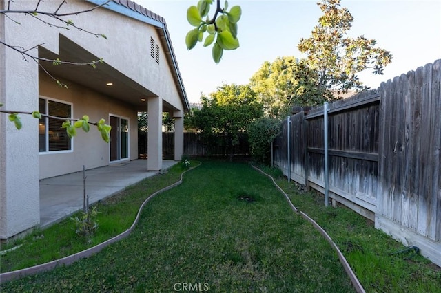 view of yard with a patio area and a fenced backyard