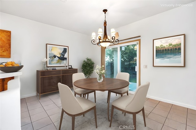 dining space featuring a chandelier, light tile patterned floors, and baseboards