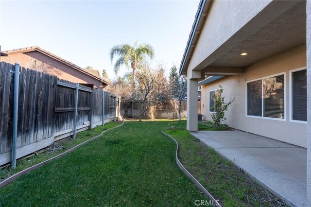 view of yard with a patio area and a fenced backyard