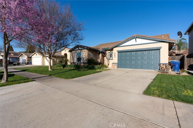 ranch-style home with a garage, concrete driveway, stucco siding, fence, and a front yard