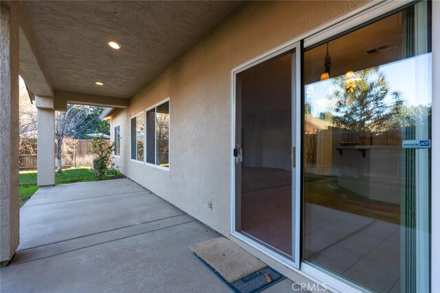 view of patio featuring fence and visible vents