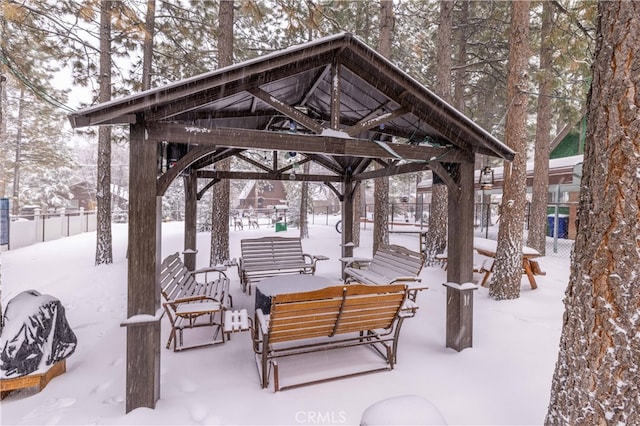 view of home's community with fence, an outdoor living space, and a gazebo