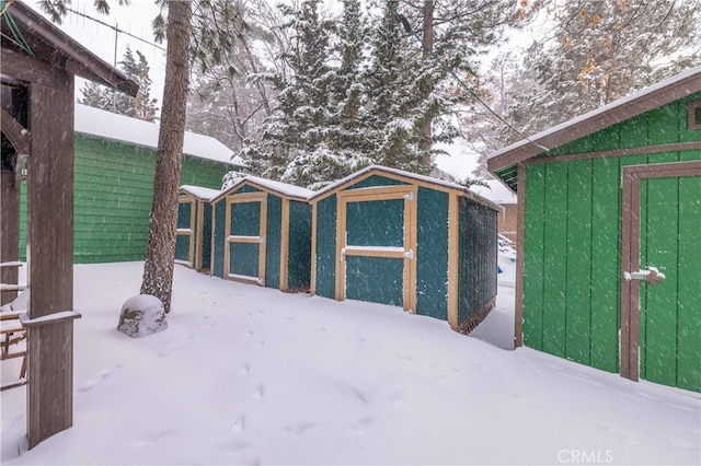 yard layered in snow with an outdoor structure and exterior structure