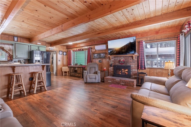 living area featuring wooden ceiling, a fireplace, dark wood finished floors, and beamed ceiling