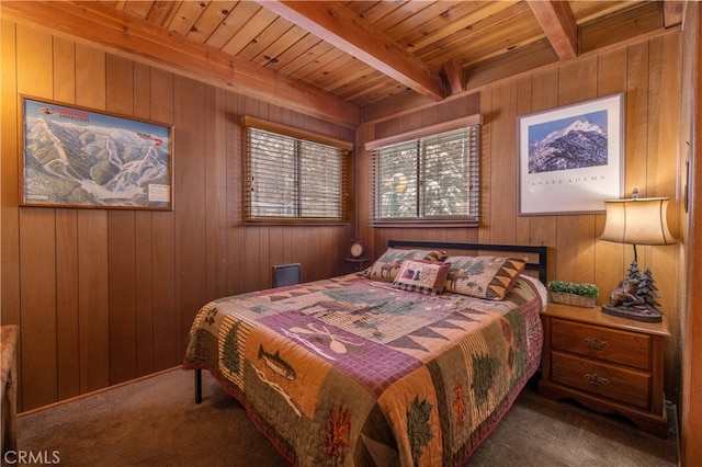 carpeted bedroom featuring visible vents, wood walls, wooden ceiling, and beam ceiling