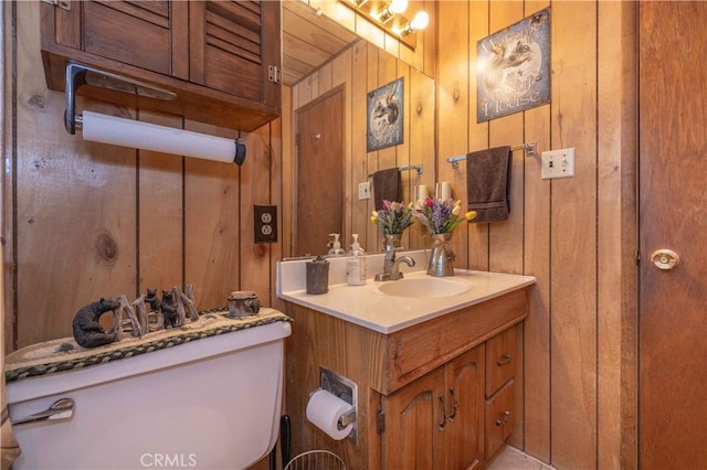 bathroom featuring wooden walls and vanity