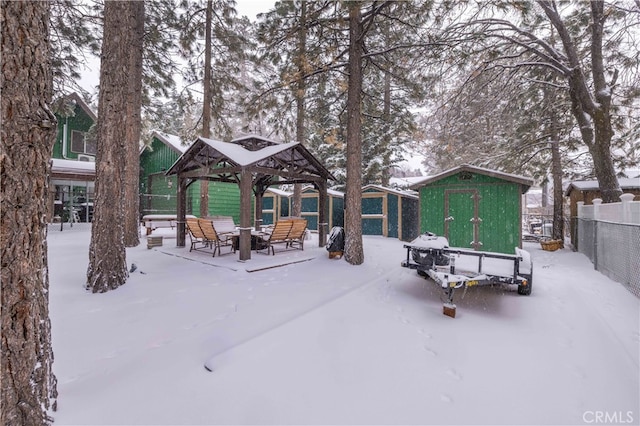 view of property's community with an outbuilding, fence, a gazebo, and a shed