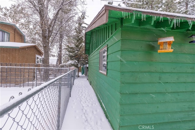 view of side of property featuring fence