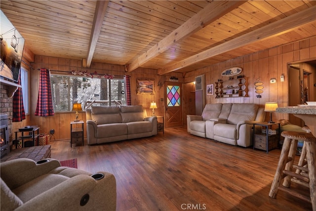 living room with beam ceiling, wooden ceiling, wood walls, and wood finished floors