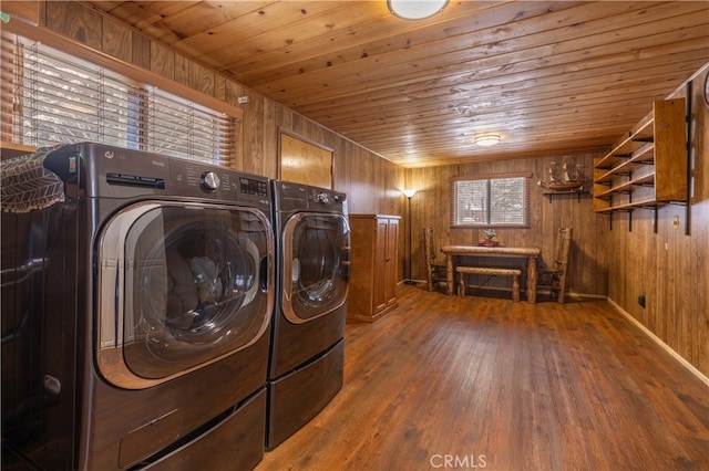 washroom with laundry area, wood ceiling, wood finished floors, wood walls, and separate washer and dryer