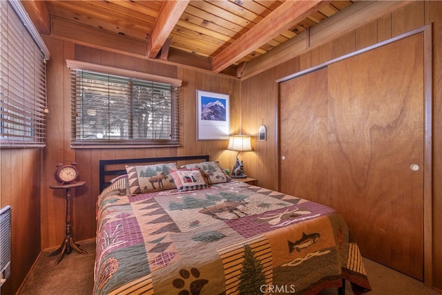 carpeted bedroom featuring wood walls, wood ceiling, a closet, and beamed ceiling