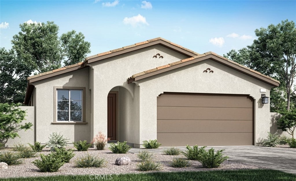 view of front facade with a garage, a tile roof, driveway, and stucco siding