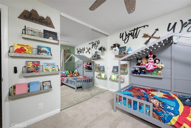 playroom with baseboards, ceiling fan, and carpet floors