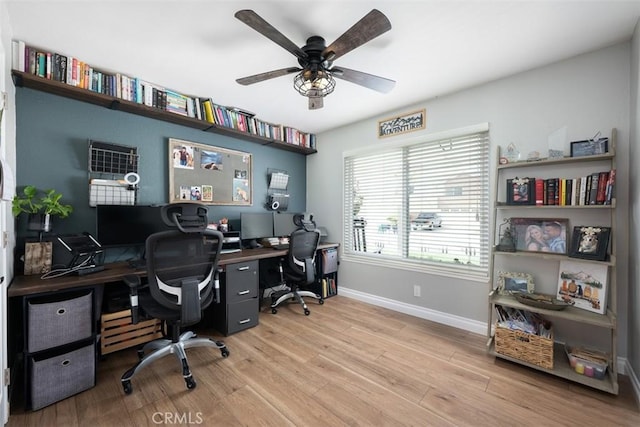 office space with a ceiling fan, wood finished floors, and baseboards