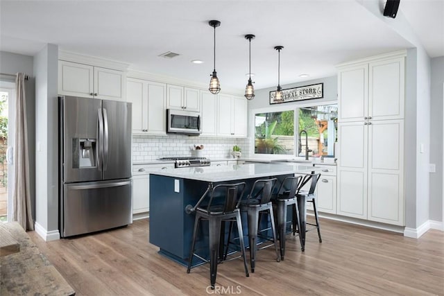 kitchen featuring a sink, stainless steel appliances, and white cabinets