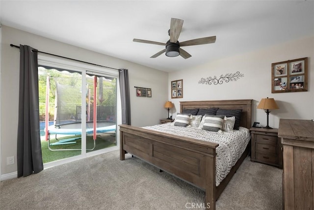 carpeted bedroom featuring access to exterior, a ceiling fan, and baseboards