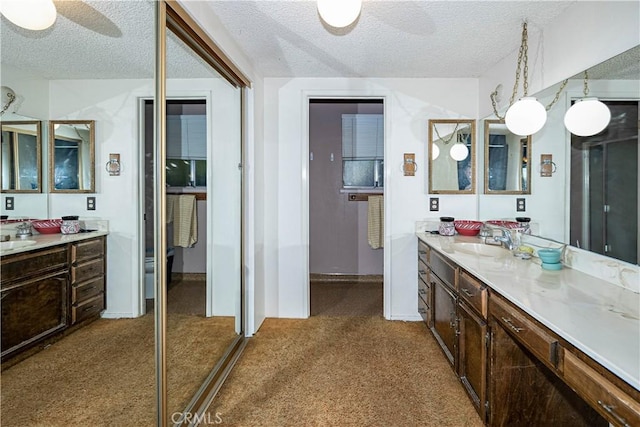 full bathroom with carpet, ceiling fan, vanity, and a textured ceiling