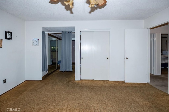 unfurnished bedroom with carpet floors, a closet, a textured ceiling, and a ceiling fan