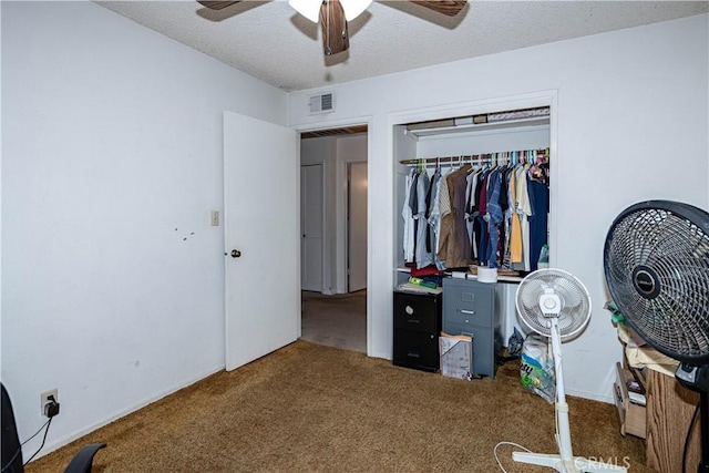 carpeted bedroom featuring a ceiling fan, a textured ceiling, visible vents, and a closet