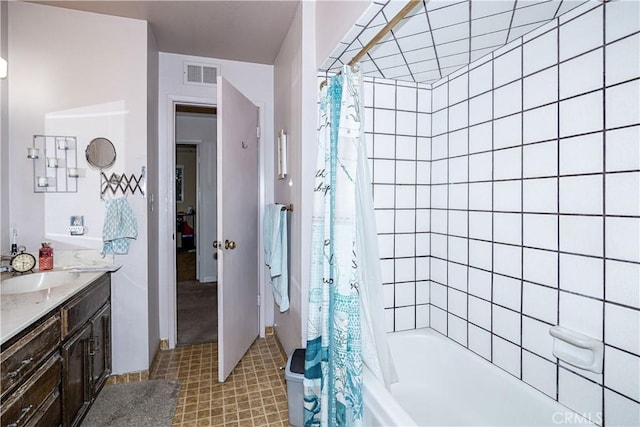 bathroom featuring visible vents, shower / bath combo with shower curtain, and vanity