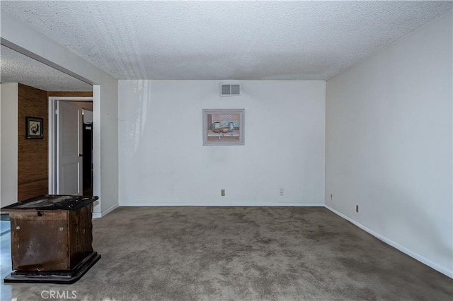 unfurnished living room featuring carpet floors, baseboards, visible vents, and a textured ceiling