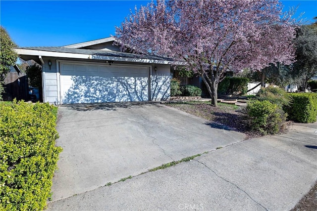 view of property exterior with concrete driveway and an attached garage