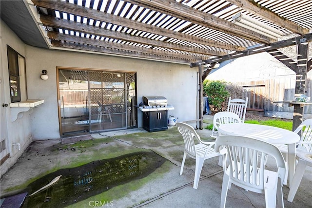 view of patio / terrace with outdoor dining area, area for grilling, and fence