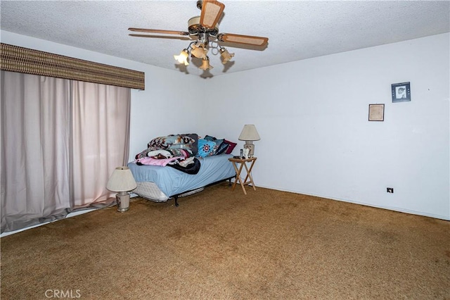 bedroom with a textured ceiling, carpet floors, and a ceiling fan