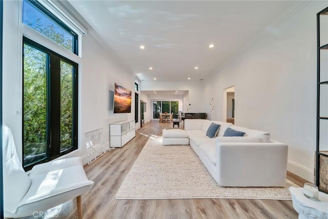 living room with crown molding, recessed lighting, plenty of natural light, and light wood finished floors