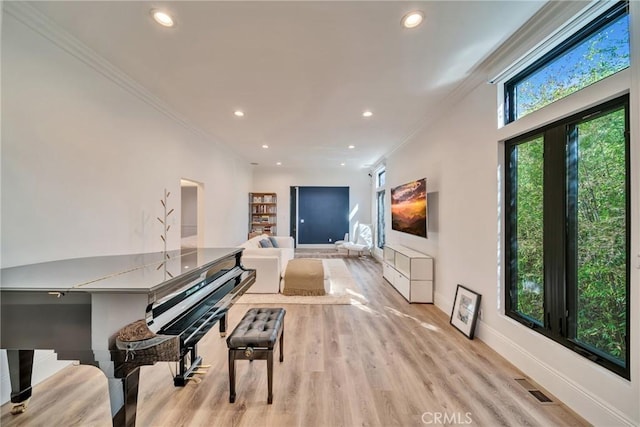 living area with recessed lighting, visible vents, and crown molding