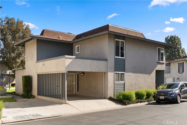 view of property featuring concrete driveway and a garage