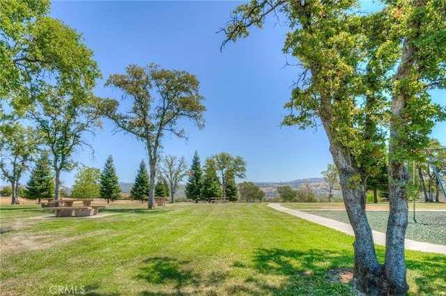 view of property's community with a lawn