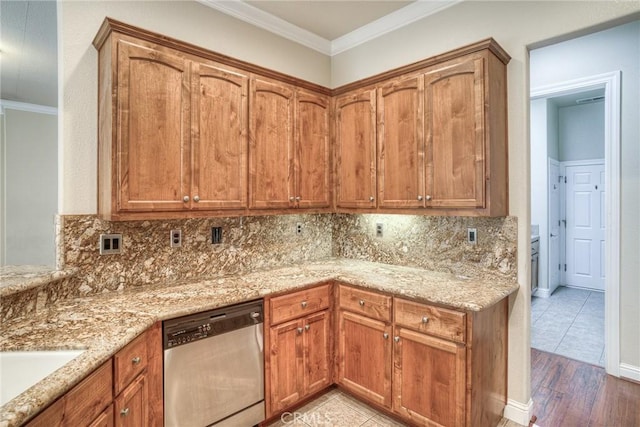 kitchen featuring ornamental molding, stainless steel dishwasher, brown cabinetry, and light stone counters